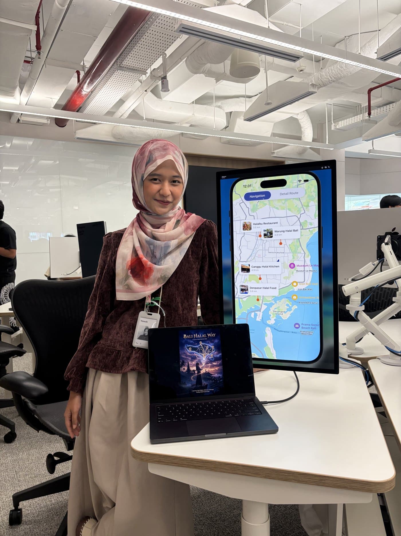 Ni'mah presenting Bali Halal Way at Apple Developer Academy with the app on a large display