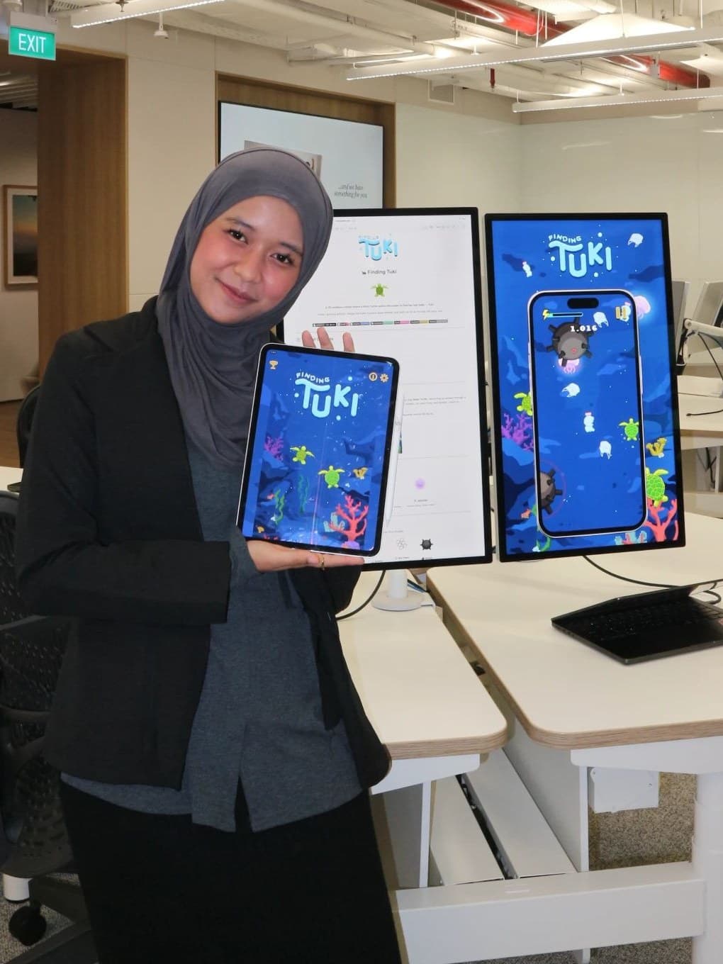 Ni'mah presenting Finding Tuki on iPad and monitors at Apple Developer Academy